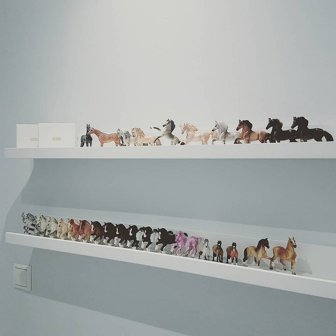 Wąskie półki IKEA w pokoju dziecka na zabawki i książki przy łóżku. Organizacja.