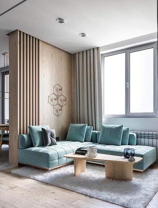 Turkusowa kanapa w salonie Turkusowa kanapa w salonie z drewnianymi elementami i dywanem, idealna do aranżacji wnętrz w stylu loft.