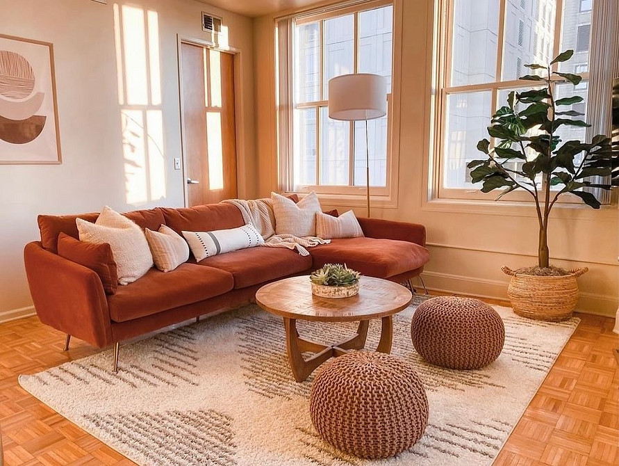 Zielona kanapa Zjawiskowa zielona kanapa w naturalnym wnętrzu z akcentami drewna i roślin.