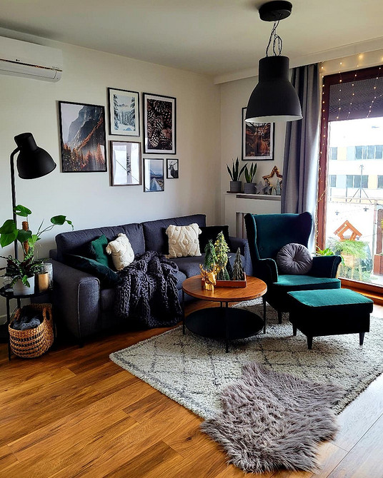 Kanapa i ściany Harmonijne połączenie koloru ściany i granatowej kanapy w nowoczesnym salonie.