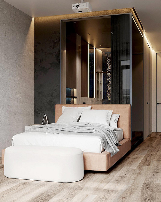 Nowoczesna sypialnia z łóżkiem z miękkim zagłówkiem i dekoracyjnymi poduszkami.