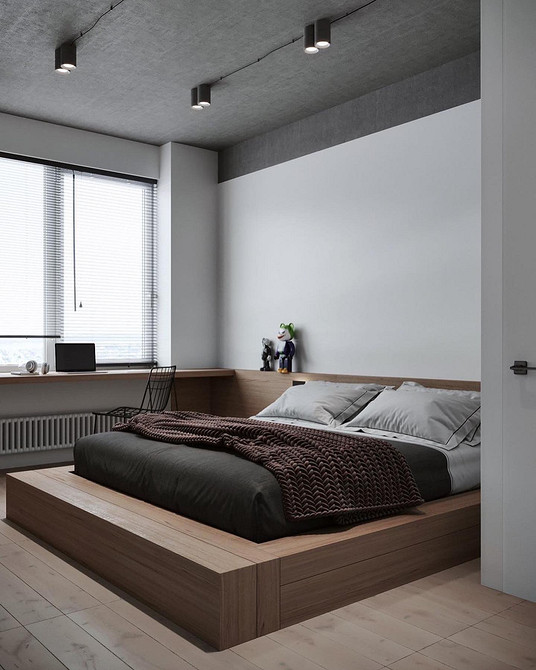 Łóżko na podium w nowoczesnej sypialni, wyraźne strefowanie przestrzeni.