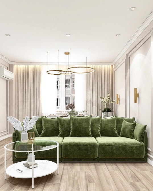Ciemnozielona sofa Ciemnozielona sofa we wnętrzu z akcentową ścianą i obrazami.
