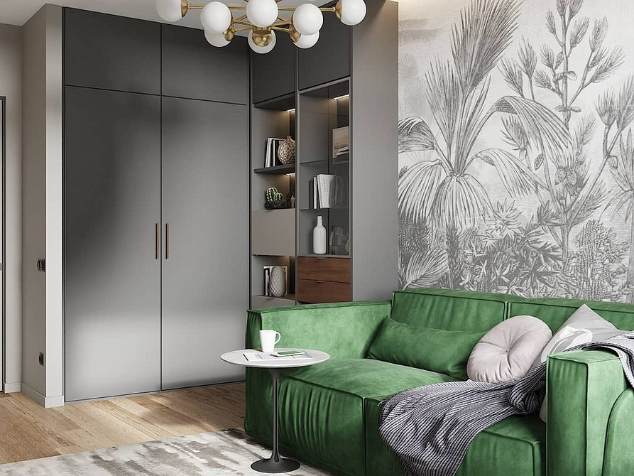 Zielona sofa z welurową tapicerką we wnętrzu salonu w połączeniu z szarością.