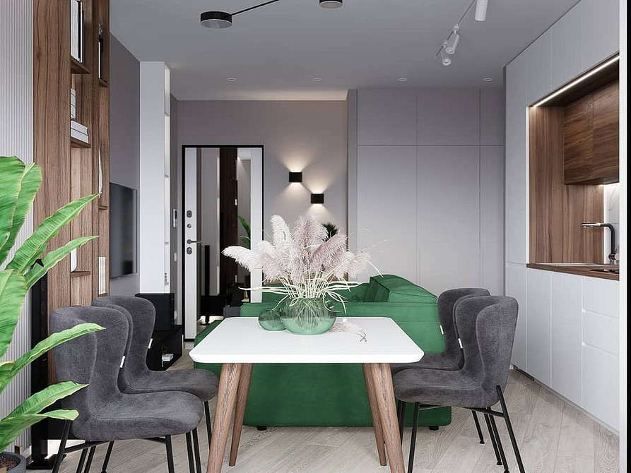 Akcent zieleni w domu Wnętrze z zieloną kanapą jako głównym akcentem, z dekoracyjnymi tekstyliami i kolorami.