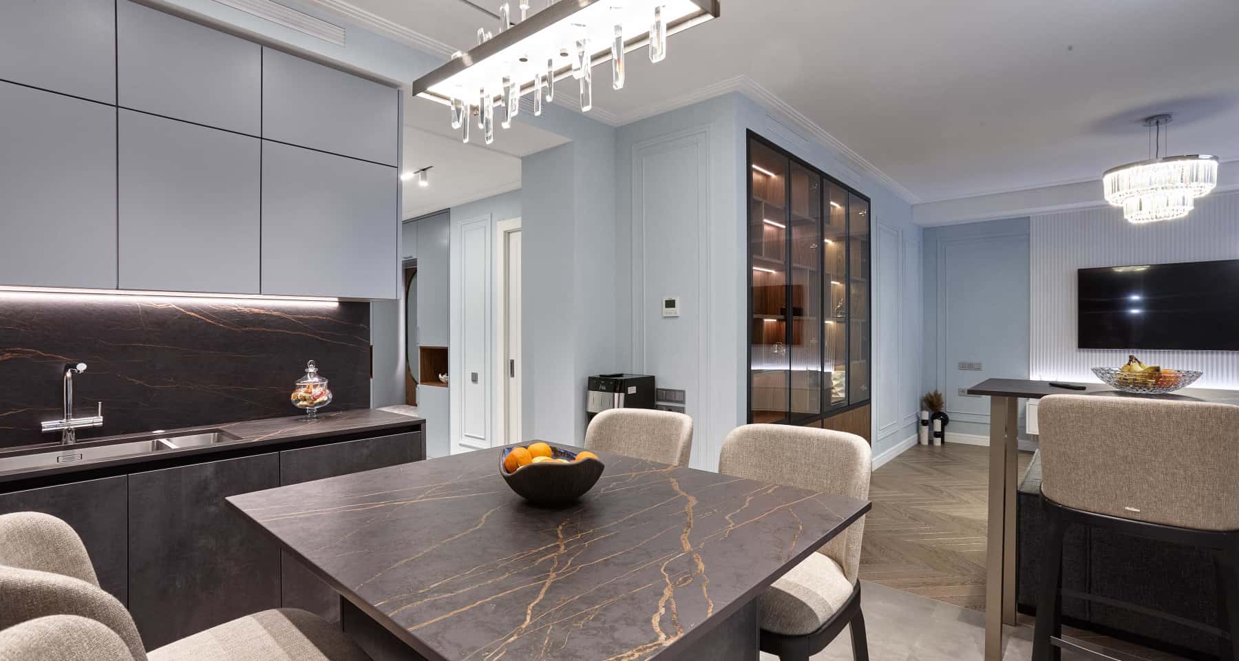 Szare wnętrza mieszkań 2026: elegancka jadalnia z szarymi krzesłami i drewnianym stołem.