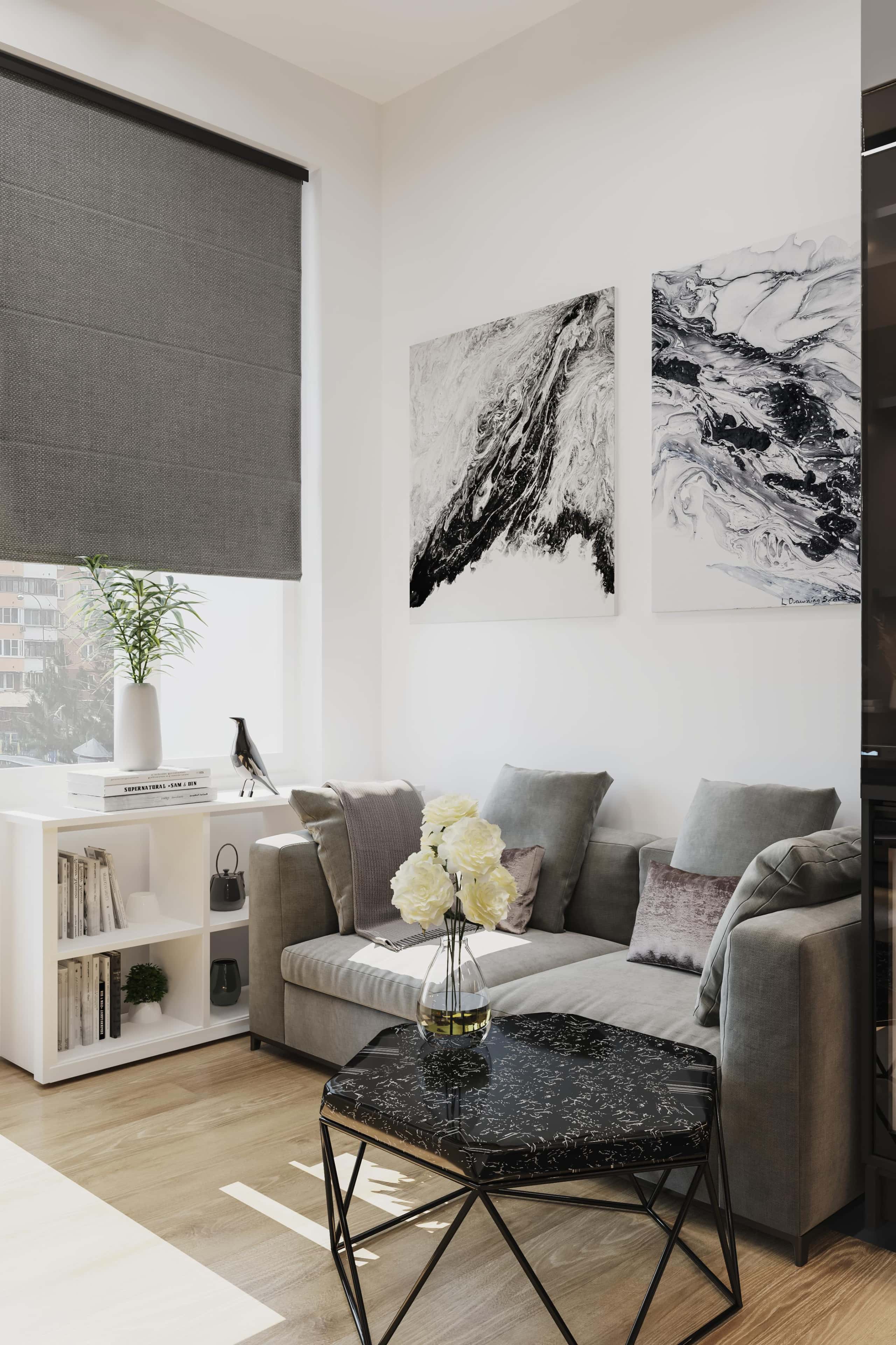 Małe mieszkanie w szarościach: funkcjonalna przestrzeń z szarą ścianą i minimalistycznymi meblami.