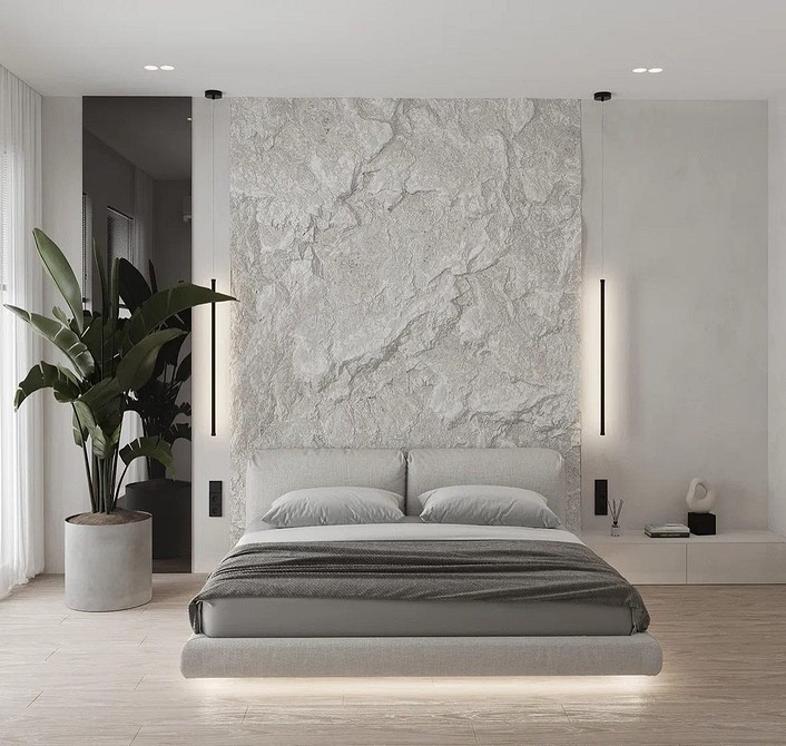 Panele gipsowe 3D w sypialni, dekoracyjne wykończenie ściany za łóżkiem i ciepłe oświetlenie.