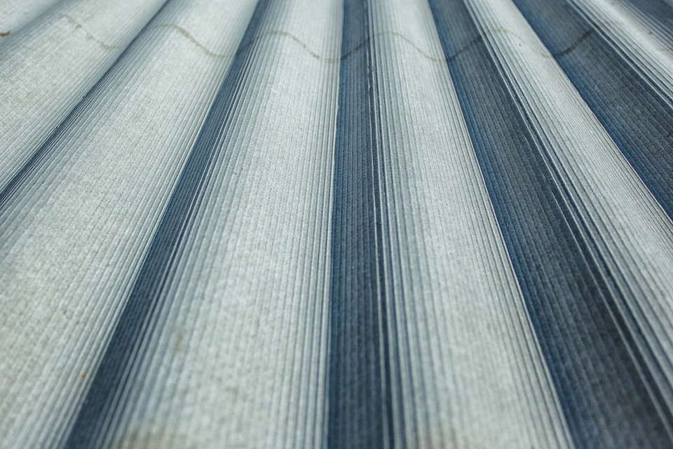 Ilustracja pokazująca montaż płyt eternitowych na elewacji budynku mieszkalnego.